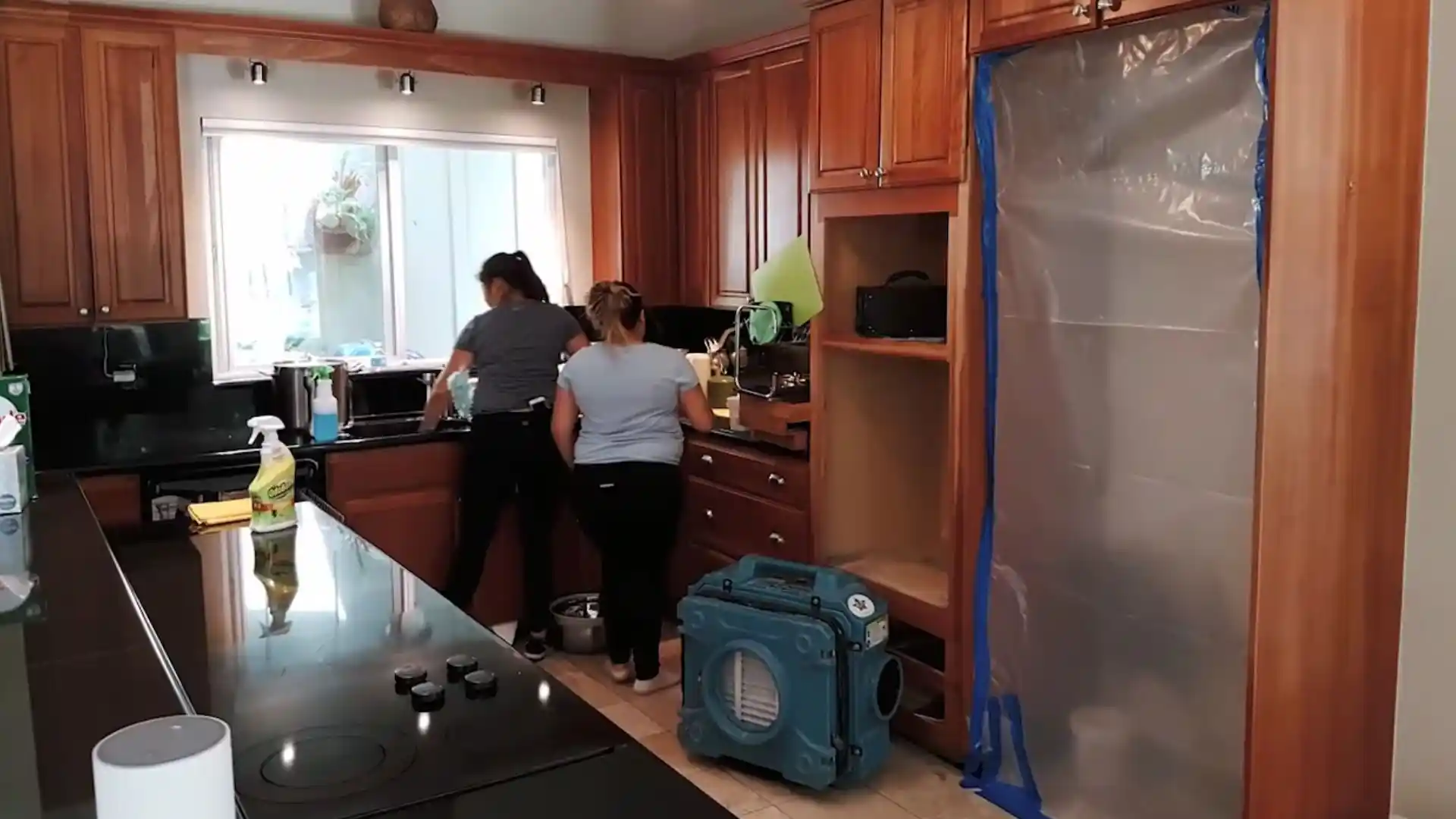 Restoration technicians working in a home during fire and water damage mitigation in Pleasant Grove, UT